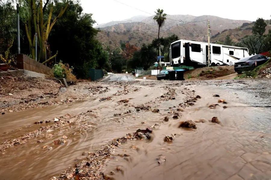 Mud and runoff washed down from the hills across a Northern California road